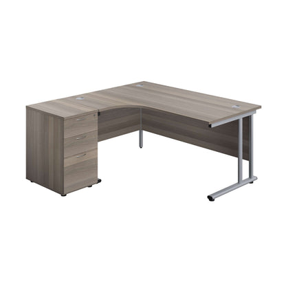 Twin Upright Left Hand Radial Desk + Desk High 3 Drawer Pedestal (FSC) | 1600X1200 | 600mm Deep Pedestal | Grey Oak/Silver